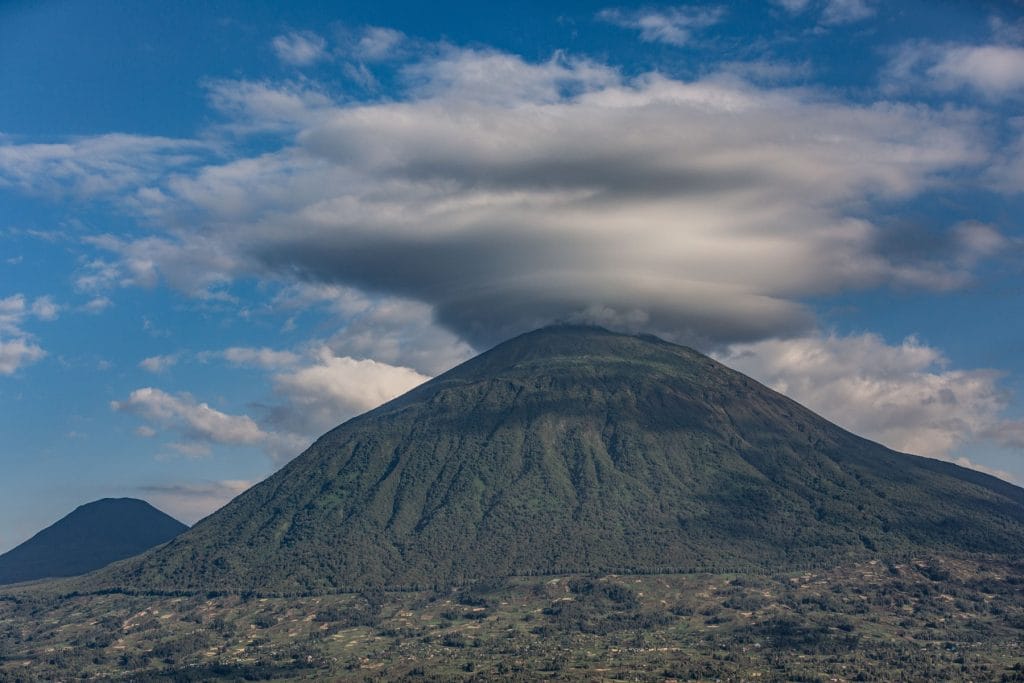 Volcanic mountain landscape in Mgahinga Gorilla National Park, Uganda, beneath dramatic cloud formations