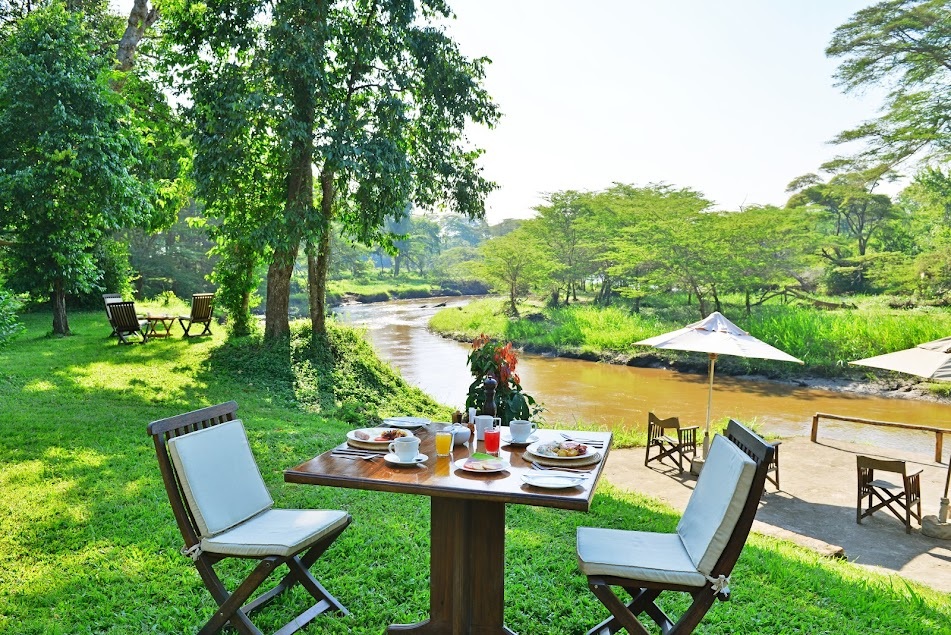 Private riverside dining experience during a luxury Uganda honeymoon safari