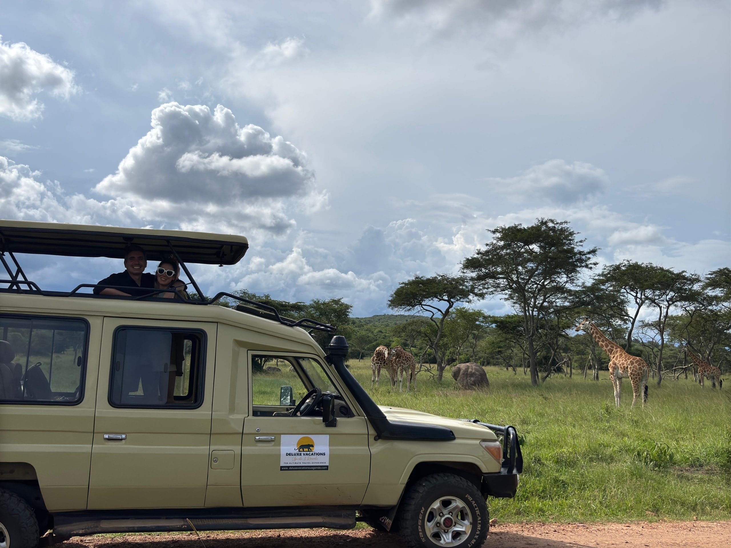 Couple on a honeymoon safari in Uganda enjoying views of the Giraffes