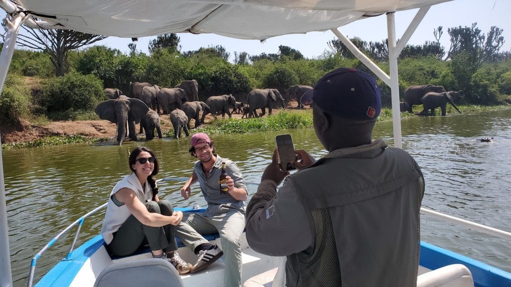 Couple enjoying a boat safari on the Kazinga Channel during a luxury Uganda honeymoon safari